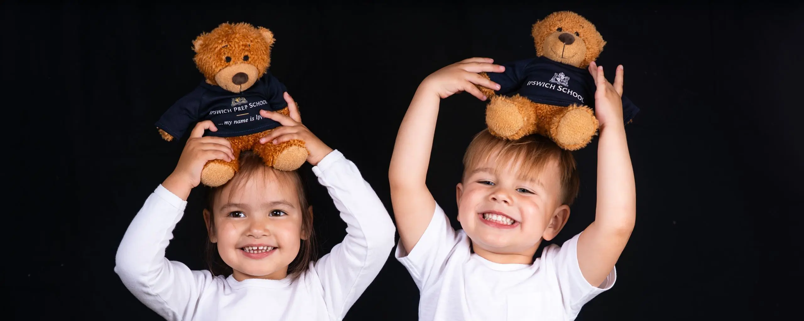 Ipswich School Nursery, The Lodge, pupils holding up teddy bears