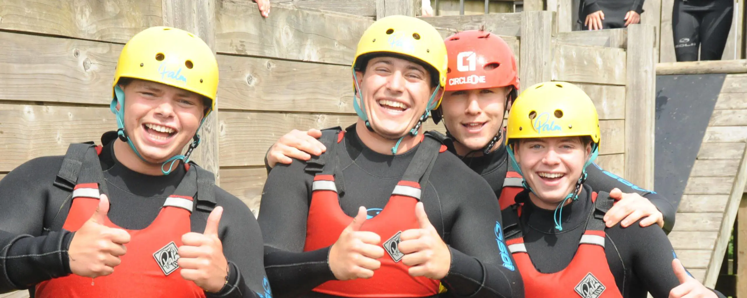 Ipswich School The Edge Programme Devon residential, pupils wearing hard hats smile and give thumbs up.