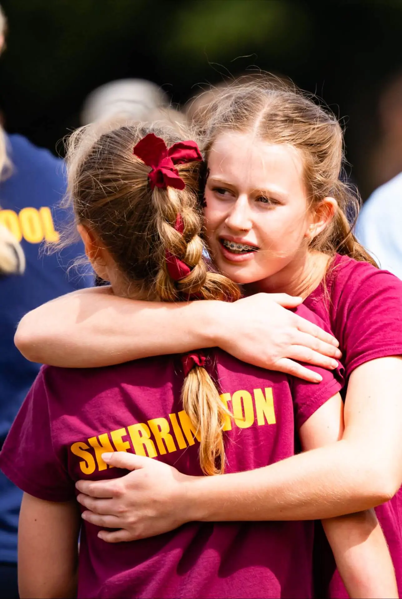 Ipswich School Senior pupils hugging on sports day.
