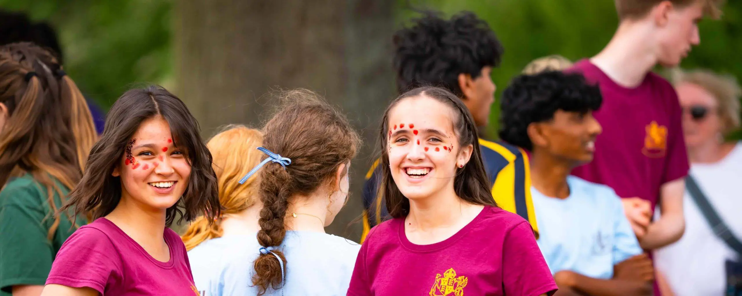 Ipswich School pupils at a school sports event wearing house t-shirts.