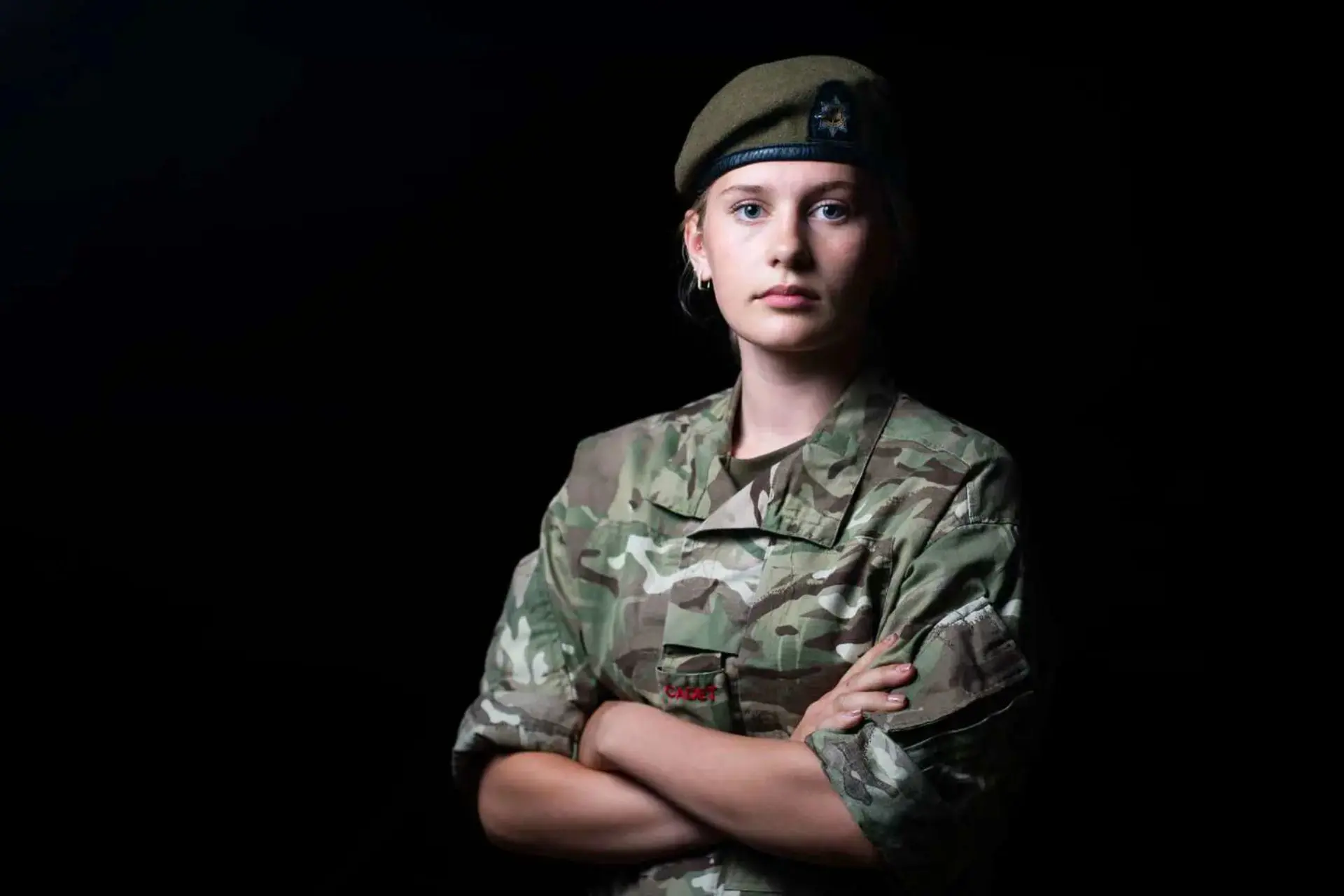  A senior girl in CCF kit, standing confidently with her arms crossed