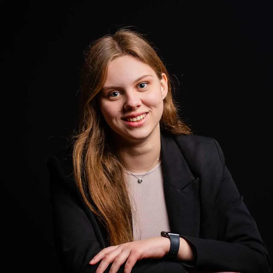 Sixth Form girl, smartly dressed in business attire, looking happy and relaxed as she meets the camera’s gaze.