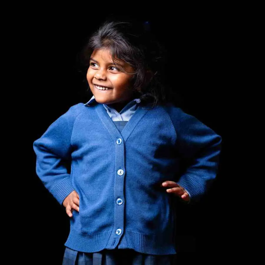 Prep Reception girl, standing proudly with a thoughtful smile, dressed in her smart uniform.